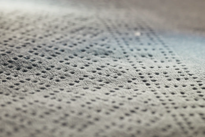 Embossed paper or fabric surface produced using rovalrolls engraved calender roll covers