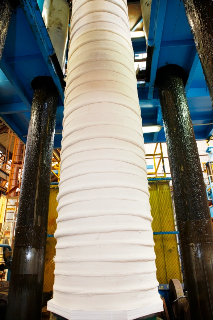 Compacting of compressed fiber roll cover under high axial pressure